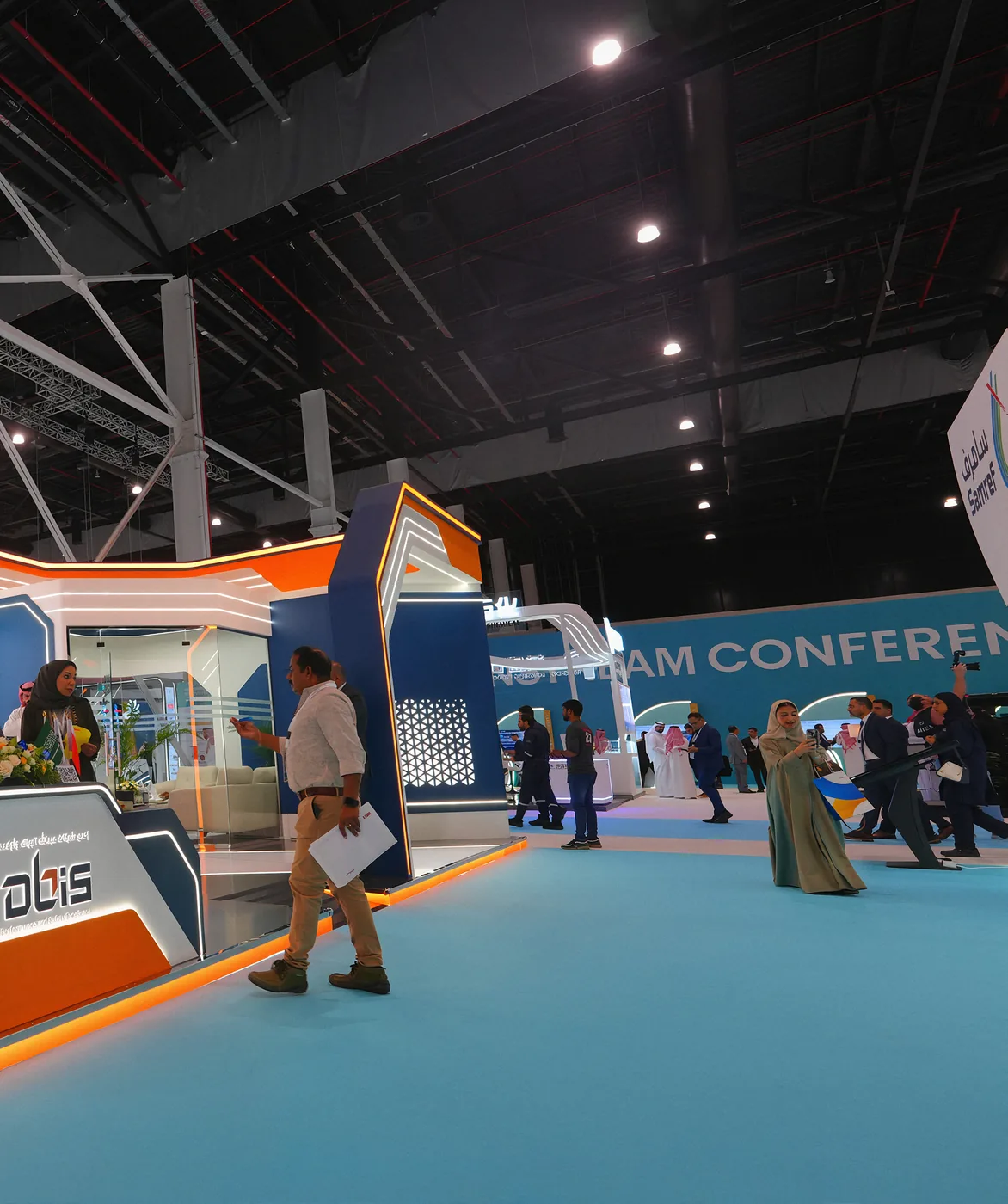 Visitors walking an exhibition aisle